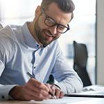 A picture of a business man writing in this what is content marketing article