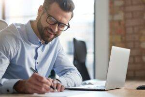 A picture of a business man writing in this what is content marketing article