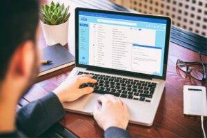 An image of a business looking at an email list in this article titled What Is Email Marketing