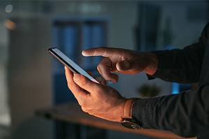 Image showing man using mobile phone in th e article title: The Future of SEO: Embracing Change and Innovation in a Dynamic Landscape