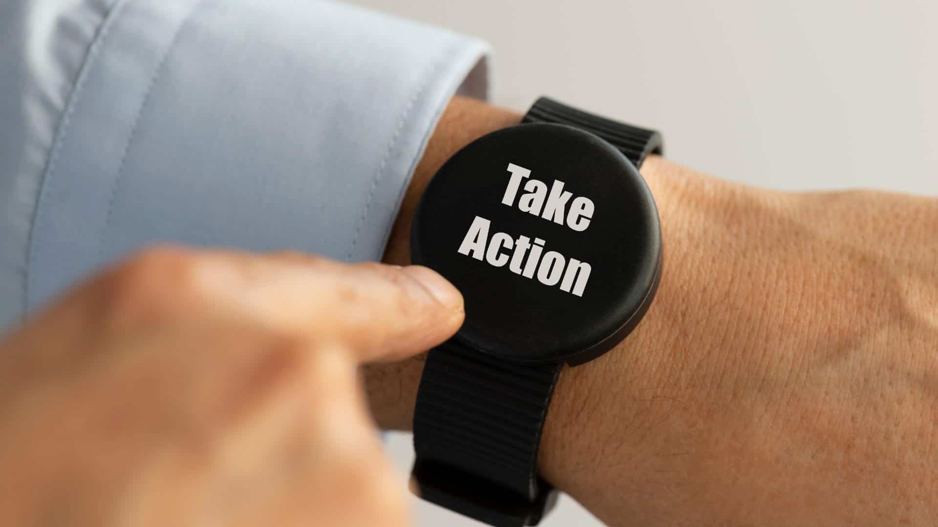 Image showing hand with watch and the words take action